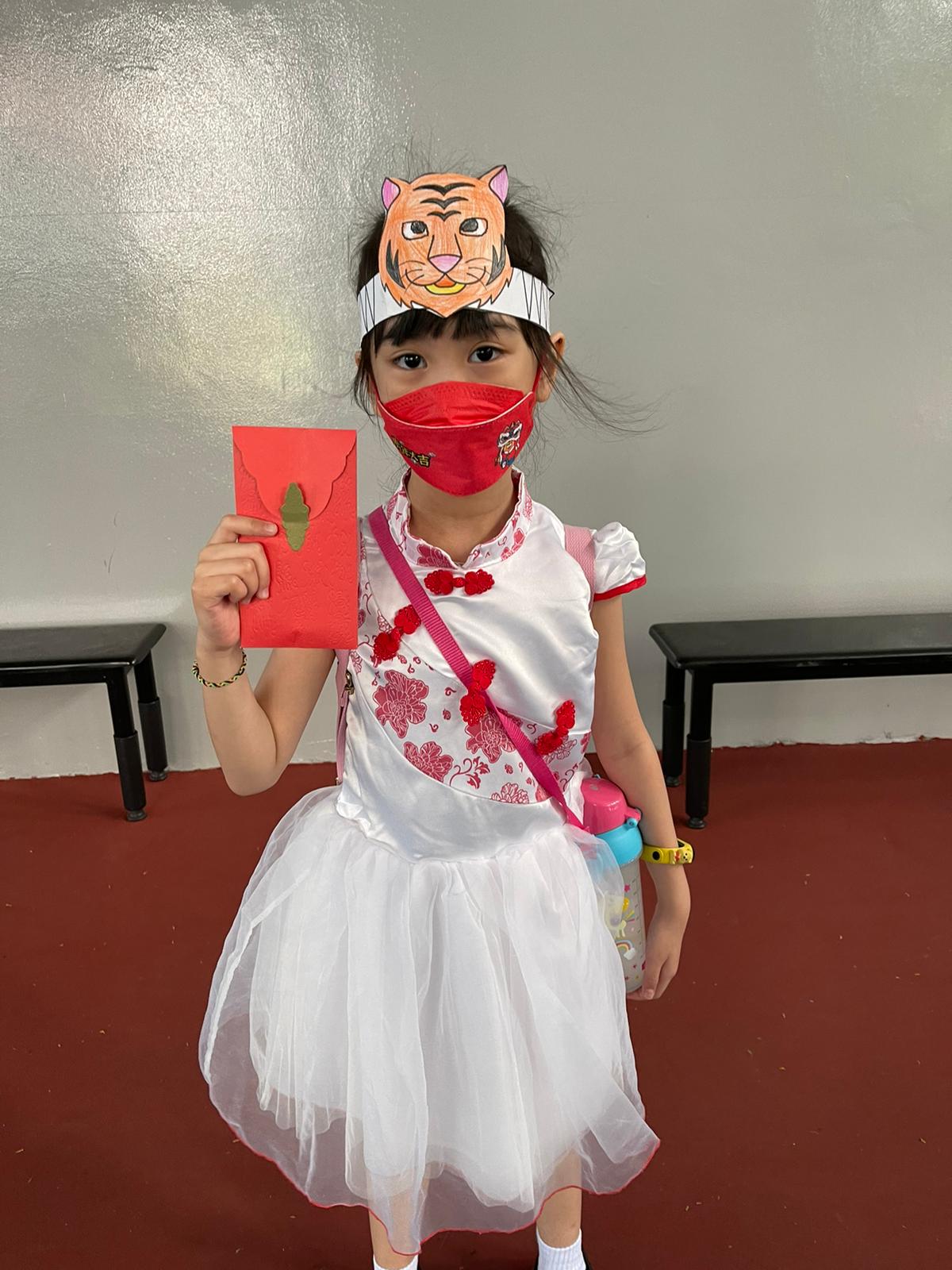 Student welcoming the Year of Tiger with her Tiger head band and Ang Bao